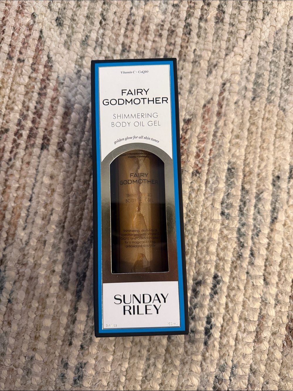 Sunday Riley Fairy Godmother Shimmering Body Oil Gel — gold and white packaging
